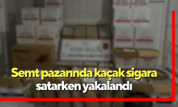 Semt pazarında kaçak sigara satarken yakalandı