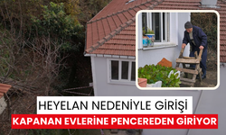 Yaşlı çift, heyelan nedeniyle girişi kapanan evlerine pencereden giriyor