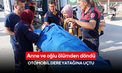 Anne ve oğlu ölümden döndü: Otomobil dere yatağına uçtu