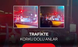 Trafikte yaşanan tekmeli, yumruklu kavgayı ayırmaya çalışan kadının zor anları kamerada