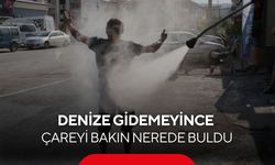 Denize gidemeyince çareyi oto yıkamacıda buldu! Tazyikli suyla serinledi