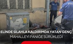 Sokak ortasında elinde tabancayla hareketsiz yatan genç paniğe neden oldu...